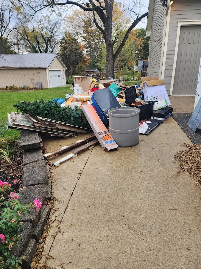 Dumpster being loaded with debris for Commercial Dumpster Rental in Upper Grand Lagoon